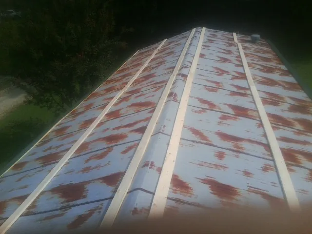 Rusted metal roof panels with new wood purlins before replacement — Storm Damage Roof Repair in Easton by Roofing Brothers